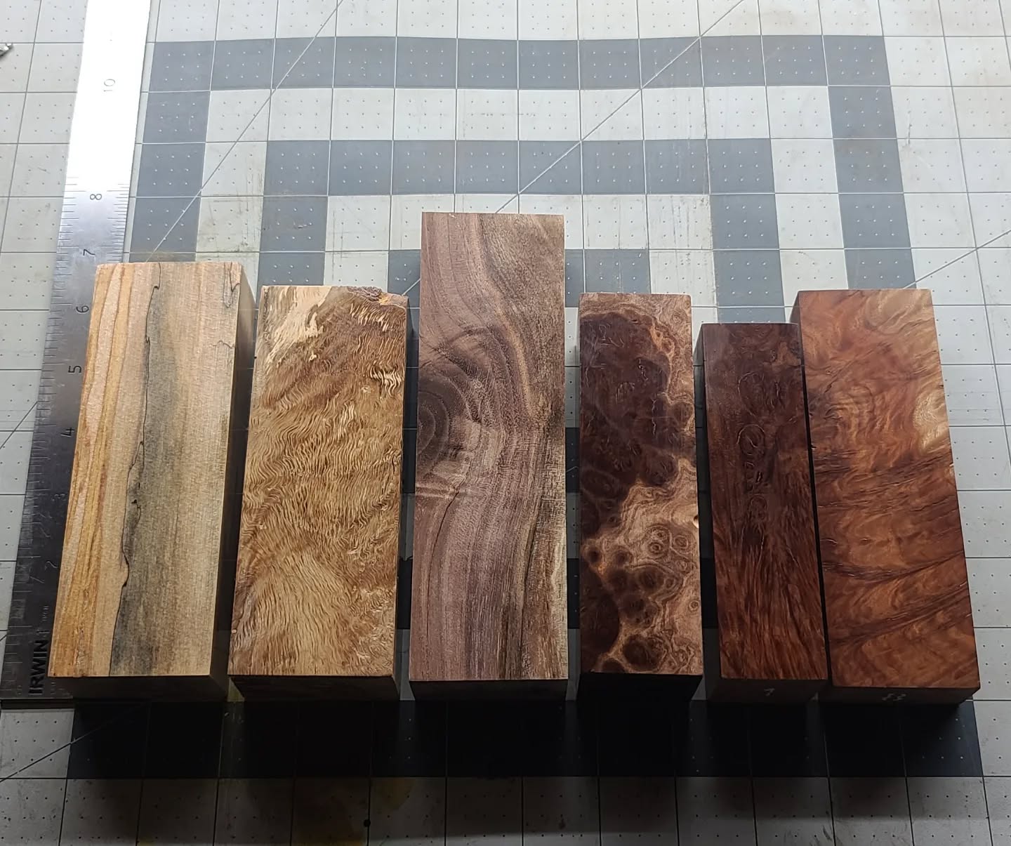 Some big changes coming up around here. I'm offloading some of my handle blocks to facilitate it. All are thoroughly stabilized at a level that often adds more weight than I've gotten with K&G blocks. If you'd like pictures of any specific block send me a DM. Blocks are numbered 1-6, left to right. Pictures don't do them justice.
This batch - 
1. Spalted Sycamore - $19
2. Red Oak Crotch - $19
3. Black Walnut - $19
4. Mallee Burl - $29
5, 6. Mallee Burl - $19
 
Sycamore is roughly 6"x2"x1.25" (you can compare sizes on the grid). Excellent for Western handles, or possibly two wa handles per block. Pricing is plus shipping (I'll combine shipping, orders $101 and up get free shipping). Payment via Cashapp, Venmo, or Facebook Messenger.